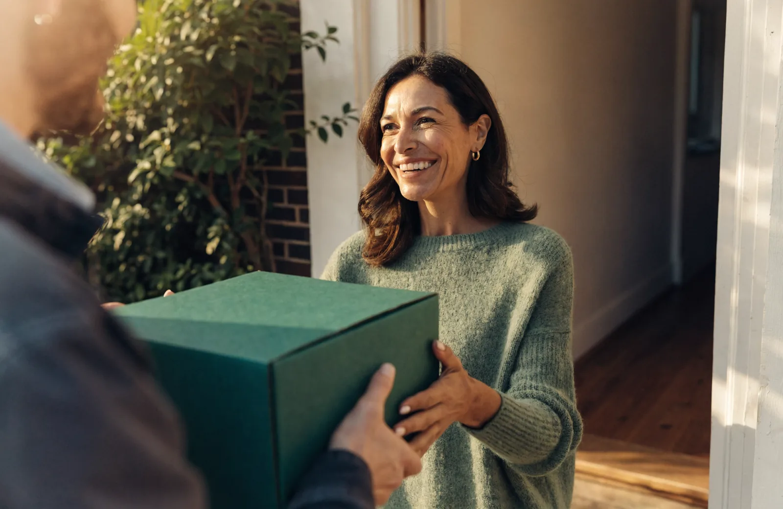 A Pharmaneek delivery arriving at a patient's front door